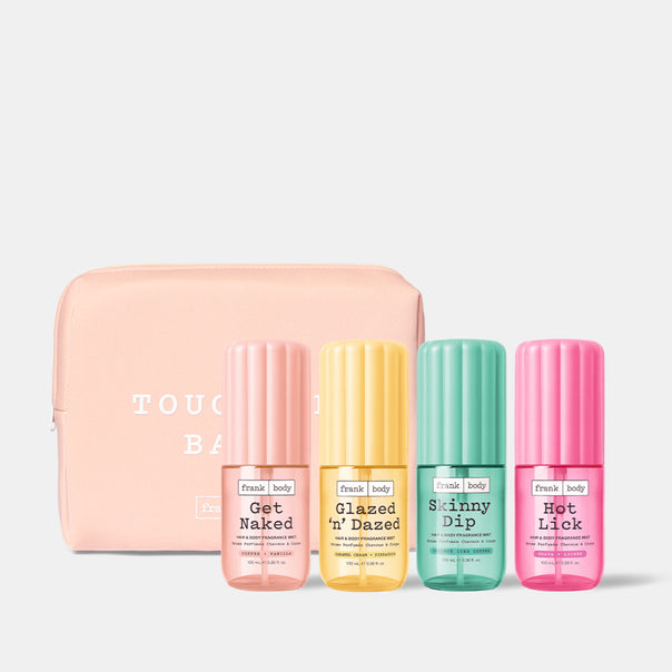 A pink frank body toiletry bag with the Get Naked, Glazed 'n' Dazed, Skinny Dip and Hot Lick Hair & Body Mists lined up in front of it.