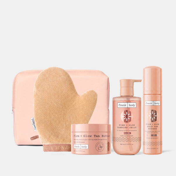 The frank body Bronze With Benefits Kit: a pink pouch, tanning mitt, Firm + Glow Tan Butter, Tanning Jelly and Self Tan Mousse.