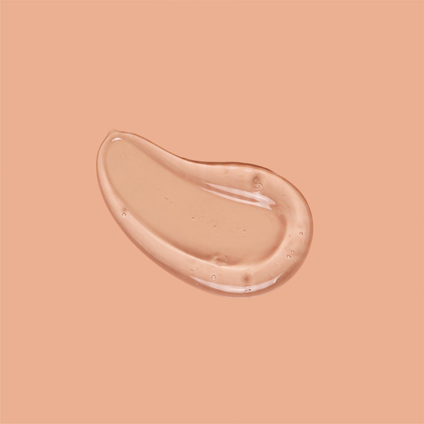 A smooth swirl of clear frank body Firm + Glow Tanning Jelly on a tan background.