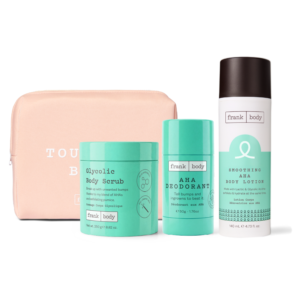 A Frank Body gift set featuring a peach-colored zippered pouch, a mint green Glycolic Body Scrub jar, a matching mint green AHA Deodorant stick, and a white and mint Green Smoothing AHA Body Lotion can, all arranged on a white background.