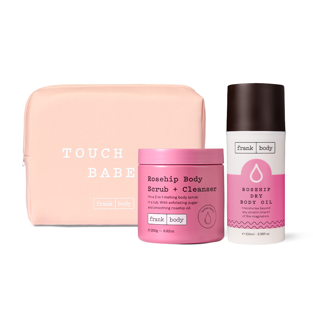 The frank body Grab My Rosehips Kit: a peach pouch reading 'Touch me, babe.' with the Rosehip Body Scrub + Cleanser and Rosehip Dry Body Oil.