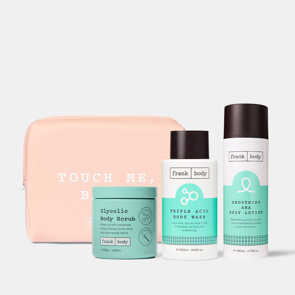 Hit The Spot Kit: a pink Touch Me Babe pouch with frank body Glycolic Body Scrub, Triple Acid Body Wash and Smoothing AHA Body Lotion.