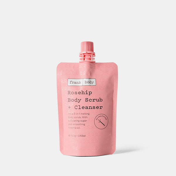 A pink stand-up pouch of Frank Body Rosehip Body Scrub + Cleanser with a matching pink cap, centered on a light gray background.