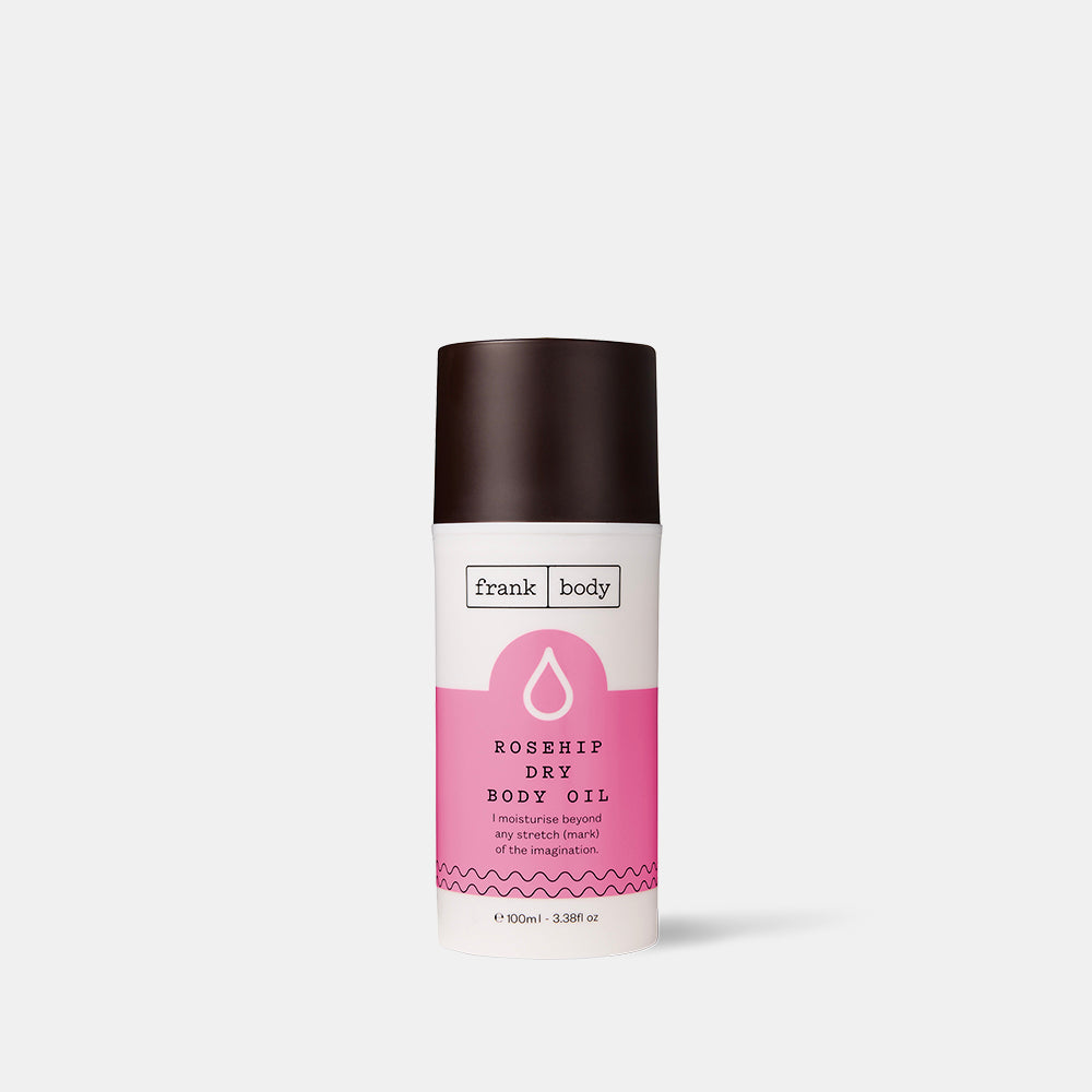 Body oil bottle with pink label on a white background